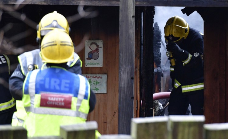 Firefighters work at the London Zoo on Saturday after a fire broke out near the cafe in the early morning.