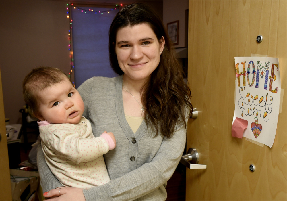 Kayla Clifton and her daughter Lilly stand in the doorway of their apartment Monday at the Mid-Maine Homeless Shelter in Waterville.