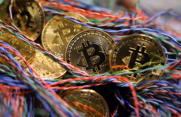 Bitcoins sit among twisted copper wiring inside a communications room at an office in London in September.