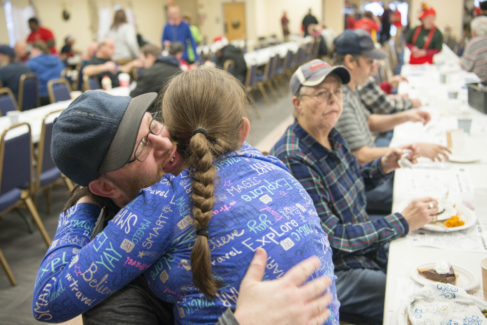 Madison Rowe, 13, gives her father, James Rowe, a hug after a turkey dinner Monday at the Elks Lodge in Waterville.