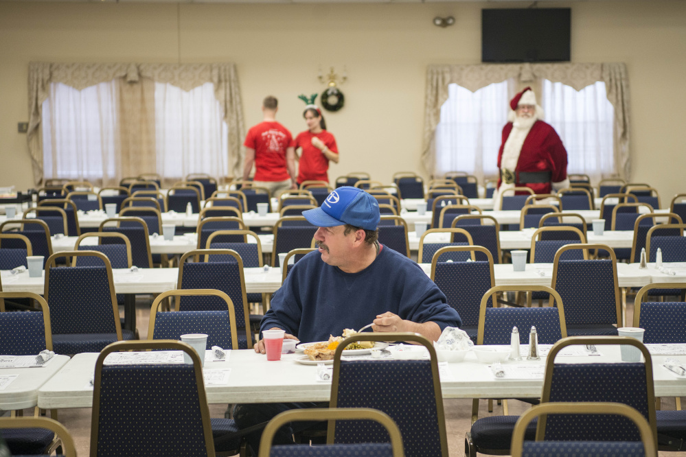 Michael Dawe sits at a table by himself Monday, Christmas Day, for the 11th annual Central Maine Family Christmas Dinner at the Elks Lodge in Waterville. If not for a major winter storm, all seats would have been occupied, judging by previous years' events.