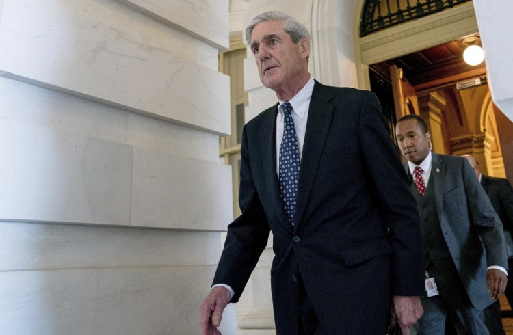 FILE - In this June 21, 2017, file photo, former FBI Director Robert Mueller, the special counsel probing Russian interference in the 2016 election, departs Capitol Hill in Washington. President Donald Trump's transition organization is arguing that a government agency improperly turned over a cache of emails to Mueller as part of his investigation into contacts between Trump associates and Russia. The complaint by the transition team is the latest attempt to undermine Mueller's investigation in the public sphere. (AP Photo
