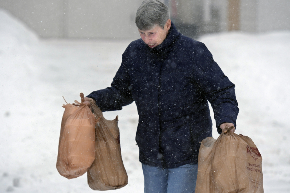 Patty Prescott delivers some of the 250 meals served Monday by the Emmanuel Lutheran Episcopal Church in Augusta.