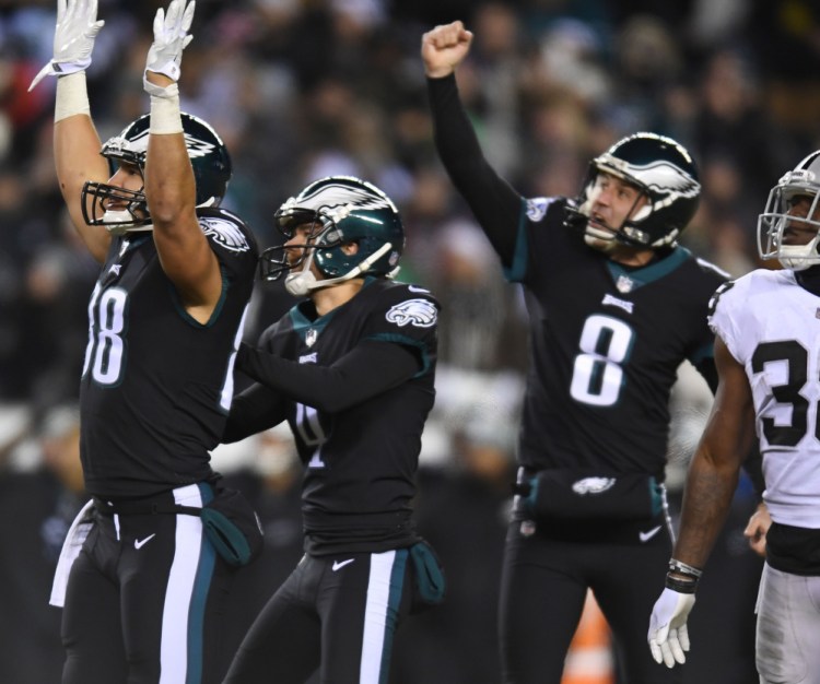 Eagles kicker Jake Elliott, center, watches his go-ahead field goal as tight end Trey Burton, left, and punter Donnie Jones celebrate during the fourth quarter of Philadelphia's 19-10 win over Oakland on Monday.