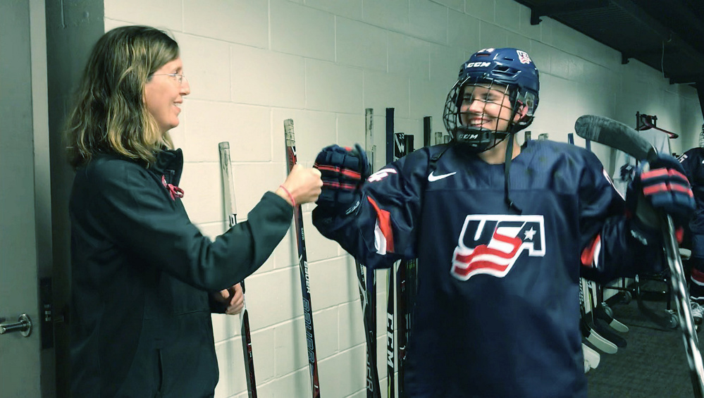 Dr. Allyson Howe, team doctor for the U.S. Women's Olympic Hockey Team, fist bumps player Dani Cameranesi of Minnesota before a recent game in San Jose, Calif. 