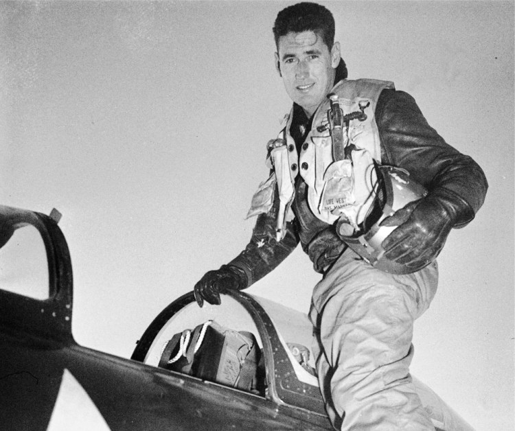 Capt. Ted Williams poses atop an airplane at a Marine air base in Korea after he crash landed his thunder jet at an advance airbase Feb. 15, 1953, on his first combat mission over North Korea against enemy targets. 