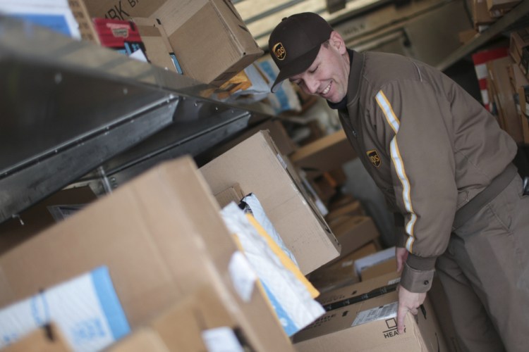 Branden Holverson poses inside a UPS truck in Idaho Falls, Idaho, in December. The on-time delivery rate for both UPS and FedEx was in the high 90s, percentage wise. At least some UPS employees worked on Sunday to deliver an estimated 750 million packages.