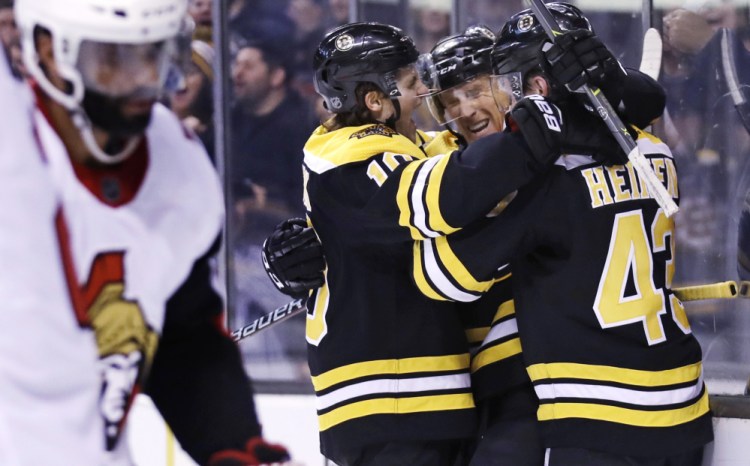 Bruins center Riley Nash, second from right, is congratulated after his goal during the second period Wednesday night against the Ottawa Senators in Boston.