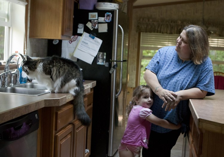 Wendy Brennan, seen with granddaughter Madelyn Begin at her Mount Vernon home in 2014, had a filter installed on her tap after she learned that her drinking water contained arsenic. More than half of Maine's wells have not been tested for the toxic element.