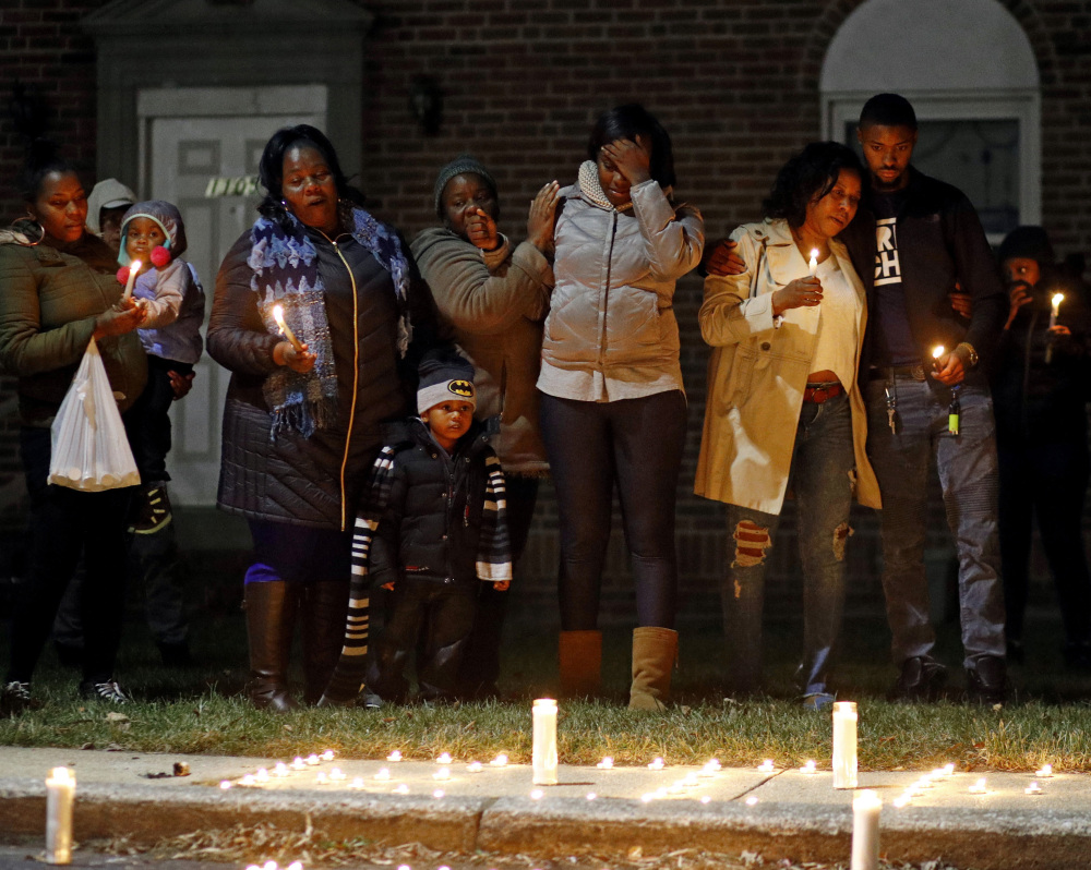Relatives of a homicide victim gather for a vigil near the scene of the murder in Baltimore, Md., where friends and family of the victim joined activist Erricka Bridgeford.