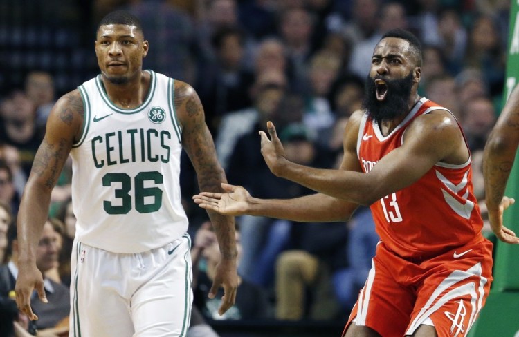 Boston's Marcus Smart, left, draw two offensive foul calls on Houston's James Harden in the closing seconds of the Celtics' win Thursday night.