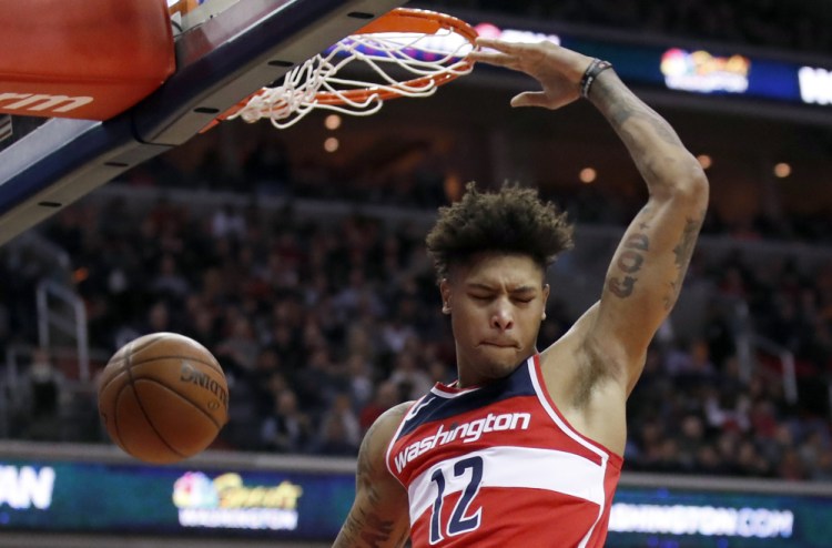Kelly Oubre Jr. of the Wizards throws down a dunk during a 121-103 win over Houston on Friday in Washington. Oubre scored 21 points and the Wizards handed the Rockets their fifth straight loss.