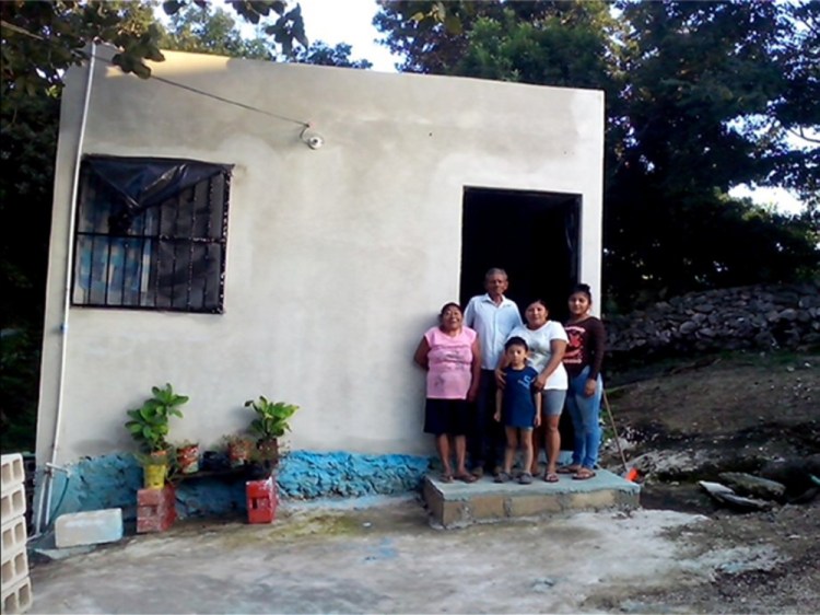 A Wayne couple put forth $8,400 to help the family of Antonia Dzul, second from right, replace a dilapidated home in the Mexican city of Tizimín with the one shown here.