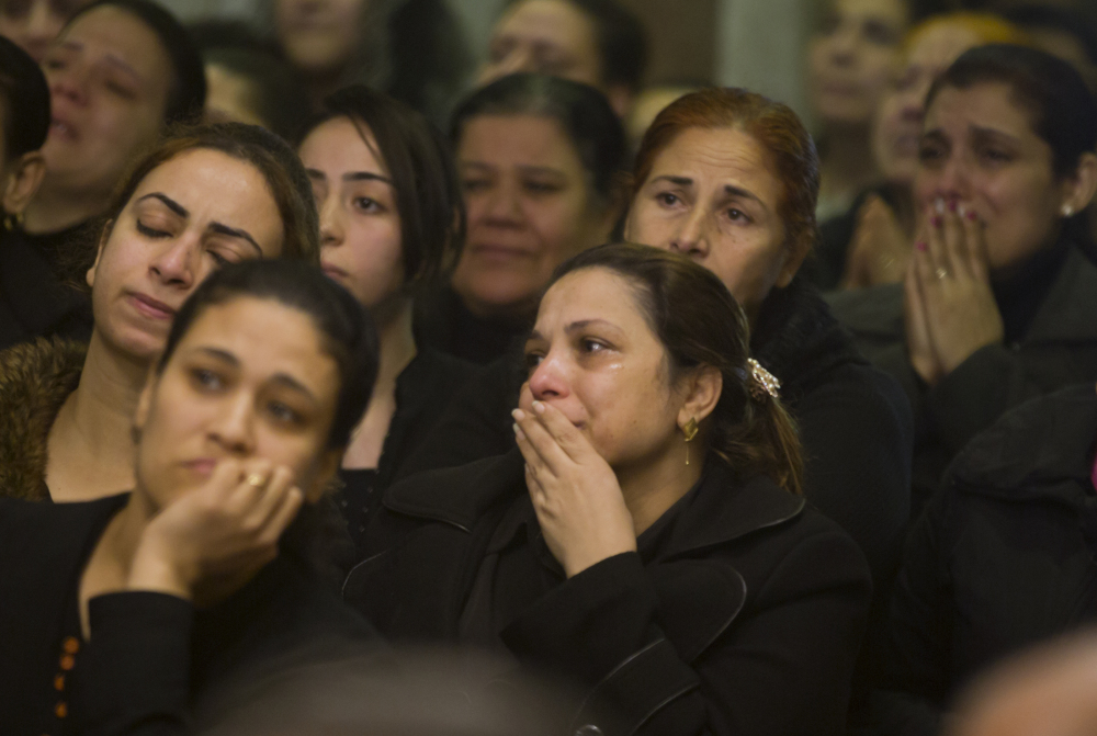 Relatives of Coptic Christians grieve during a funeral service for victims of the attack on a church in Cairo on Friday. At least nine people, including eight Coptic Christians, were killed when an unidentified gunmen opened fire outside the church.