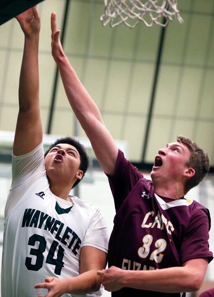 Waynflete's Dominick Campbell and Cape Elizabeth's Andrew Hartel fight for a rebound.