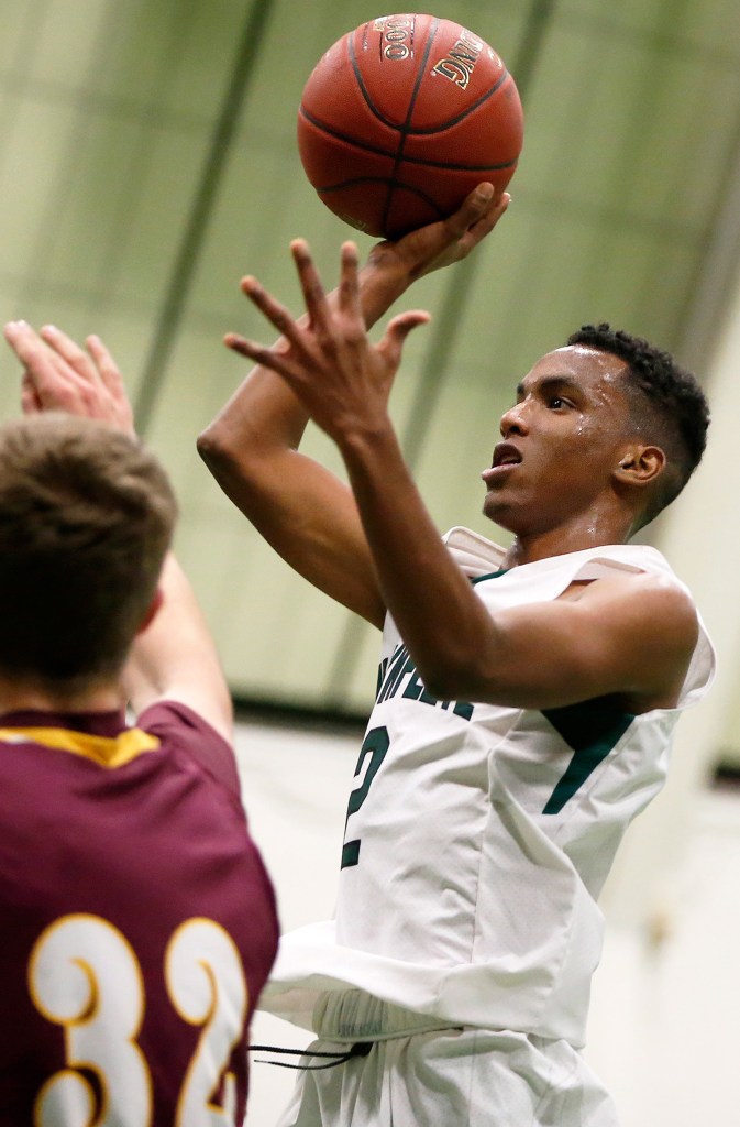 Waynflete's Askar Hussein takes a shot against Cape Elizabeth in Wednesday night's game in Portland. Hussein led the Flyers with 18 points.