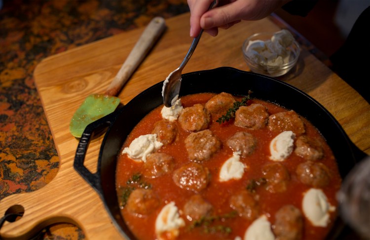 Christine Burns Rudalevige adds dollops of ricotta cheese to the veal meatball dish. 