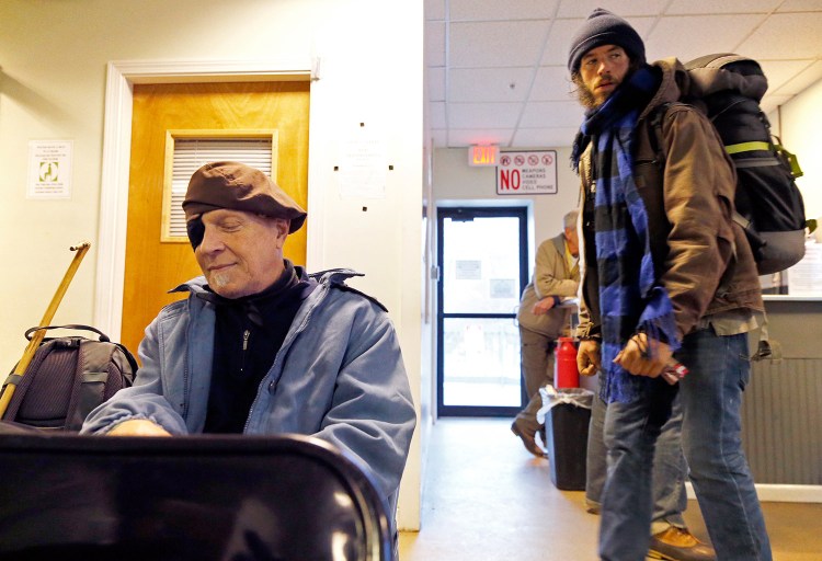 Mark Elsner, left, sits in the day room Monday at the Oxford Street Shelter, which now offers round-the-clock services to the homeless. Before Monday, people who stayed overnight in the shelter had to leave in the morning, with no place to go. "Outside is really hard," said Elsner, who has lived at the shelter for almost two months. "This will be very helpful."
