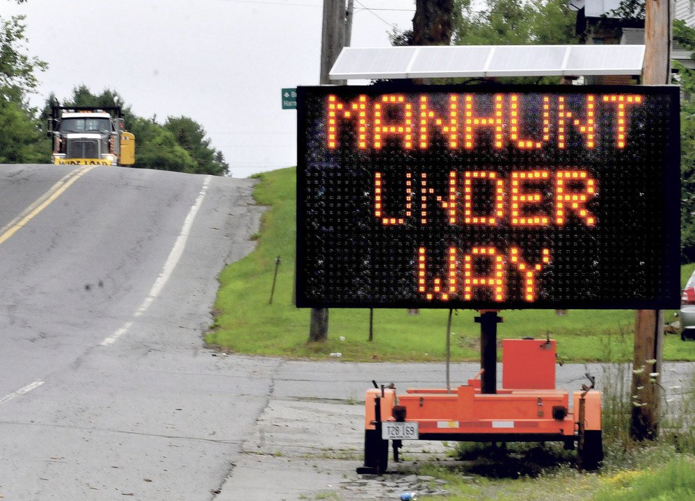A trucker comes down Route 150 on July 21, 2015, into the town of Athens near a large sign alerting people about a manhunt for murder suspect Robert Burton. Burton is scheduled to be sentenced Friday for the murder of Stephanie Gebo.