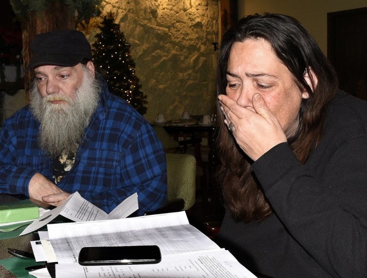 Tammy Baker breaks down and cries while she and her fiancé, Anthony Goepfert, speak on Tuesday at a Waterville hotel about a reported oil spill that made them sick at the apartment they rented at 241 Main St. in Fairfield.