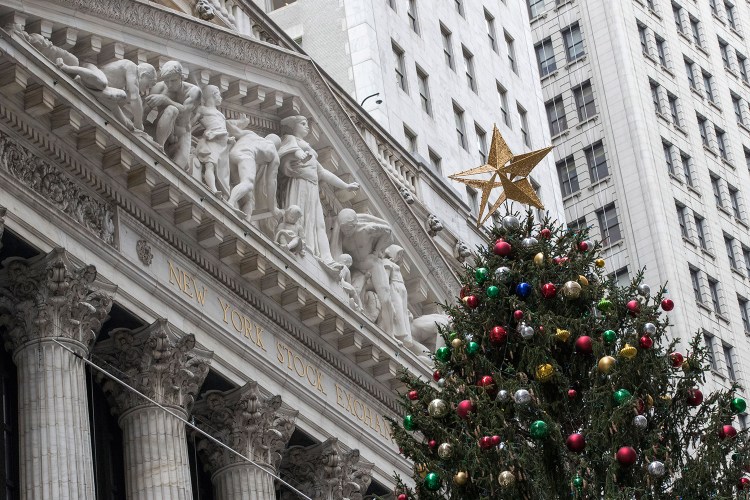 A golden star tops the Christmas tree outside the New York Stock Exchange on Thursday, when stocks powered to new highs. On Friday, however, stocks veered sharply lower on the news that former national security adviser Michael Flynn would plead guilty to lying to the FBI. 