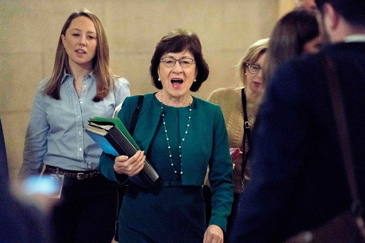 Sen. Susan Collins, R-Maine, center, arrives as Republican senators gather to meet with Senate Majority Leader Mitch McConnell, R-Ky., on the Republican effort to overhaul the tax code on Friday. Collins tweeted that she was gratified that senators agreed to incorporate her amendments into the bill.
