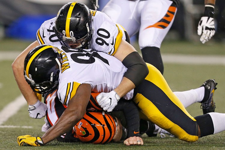 Cincinnati Bengals quarterback Andy Dalton is sacked by Pittsburgh Steelers inside linebacker Vince Williams and outside linebacker T.J. Watt (90) in the second half of Monday night's game in Cincinnati. 