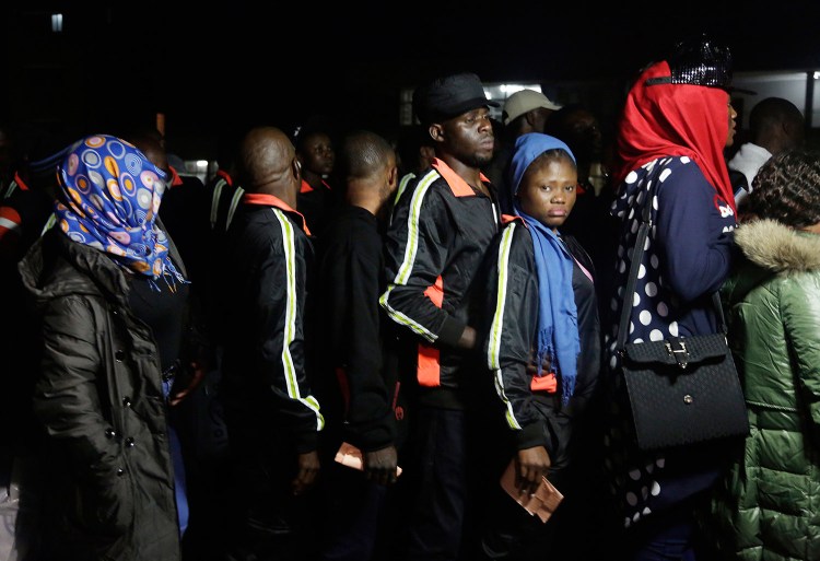 Nigerian returnees from Libya wait to be registered by officials upon arrival at Murtala Muhammed International Airport in Lagos, Nigeria, on Tuesday. Hundreds of Nigerians arrived in Lagos on Tuesday, having been repatriated from Libya by the African Union amid outrage over recent footage that showed migrants being auctioned off as slaves.