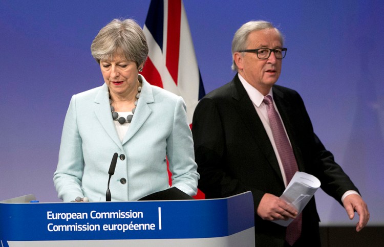 British Prime Minister Theresa May and European Commission President Jean-Claude Juncker prepare to address news media at EU headquarters in Brussels on Friday.