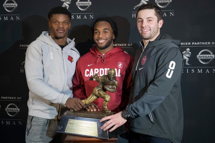 Heisman Trophy finalists, from left, Louisville quarterback Lamar Jackson, Stanford running back Bryce Love and Oklahoma quarterback Baker Mayfield pose with the award during a media event Friday in New York.