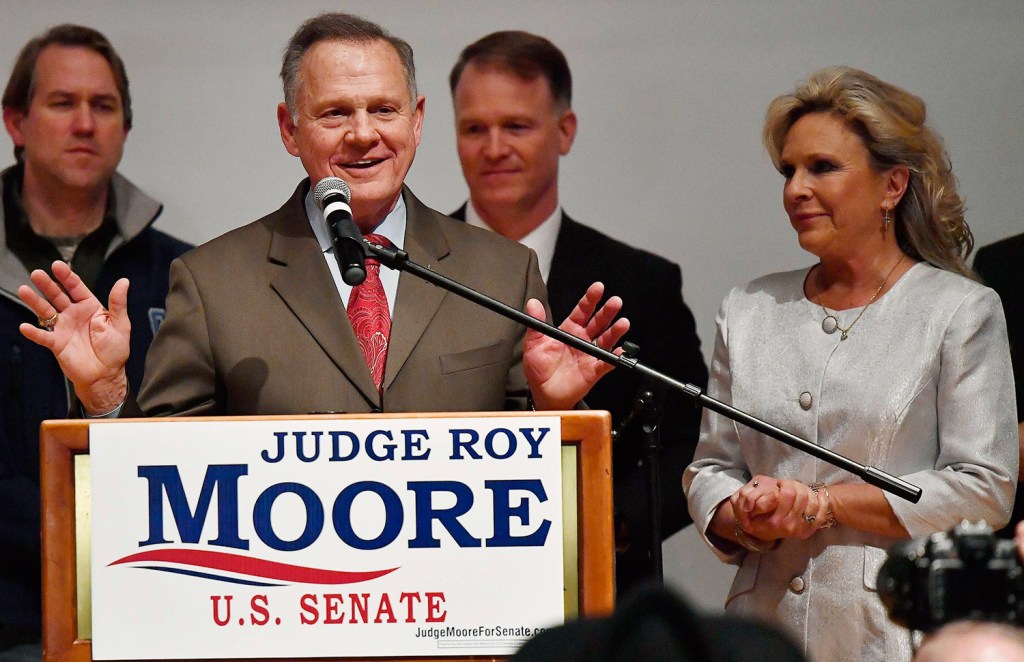 Republican Senate candidate Roy Moore speaks as his wife, Kayla Moore, right, listens Tuesday night in Montgomery, Ala. Moore did not concede to his Democratic opponent, Doug Jones, despite vote totals showing Jones the winner of a close race.