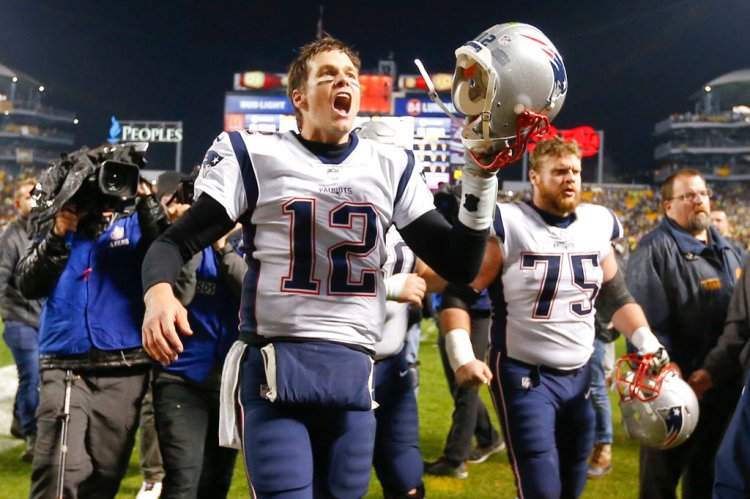 Tom Brady celebrates the Patriots' stunning victory over the Steelers as the team leaves the field in Pittsburgh Sunday. The Patriots won 27-24. 