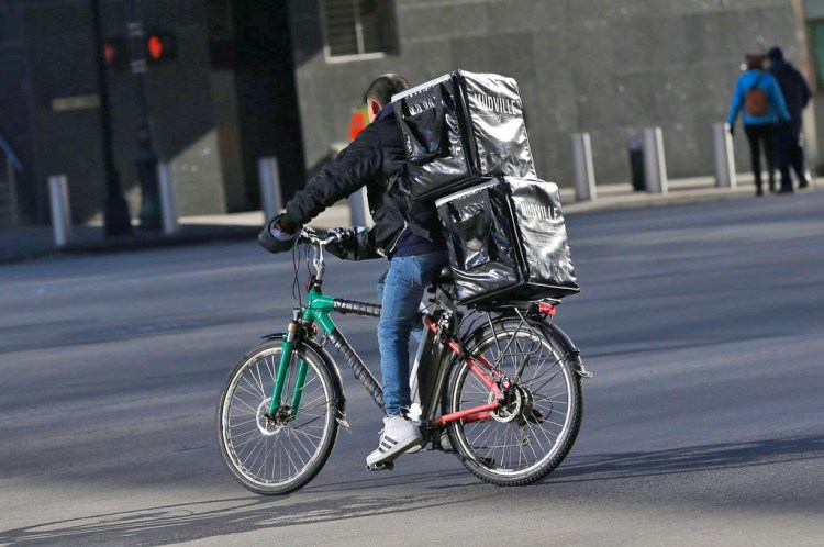 A man makes deliveries on an electric bike in New York last week. 