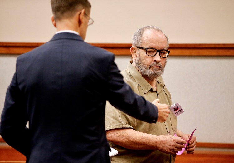 Former Jesuit priest James Francis Talbot confers with defense attorney Walter McKee after pleading not guilty to charges that he sexually abused a 9-year-old boy at a Freeport church nearly 20 years ago.