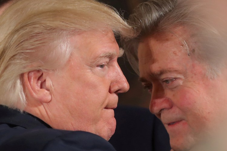 President Trump talks to then-chief strategist Steve Bannon during a swearing in ceremony for senior staff at the White House on Jan. 22, 2017. 