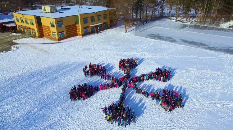 Students and staff members at Skillin Elementary School in South Portland gathered in the schoolyard Friday, forming a 430-person snowflake that was photographed from above by a drone to promote the upcoming 2018 Winter Games in January coordinated by the nonprofit WinterKids organization. Skillin is one of 16 schools across Maine selected to participate in the outdoor activity and nutrition challenge. 