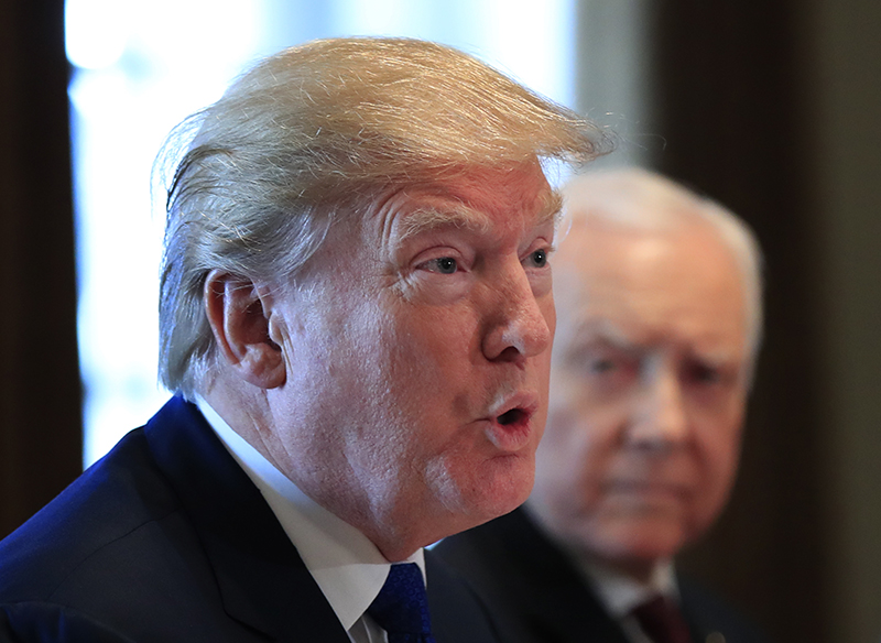 President Trump, with Sen. Orrin Hatch, R-Utah, right, speaks during a meeting with lawmakers working on the tax bill at the White House on Wednesday.