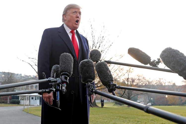 President Trump shouts to be heard over the helicopter noise as he speaks to reporters before departing for Utah from the White House Monday.  