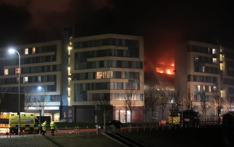 Emergency services respond to a fire at a multistory car park on Liverpool's waterfront in northwest England on Sunday. 