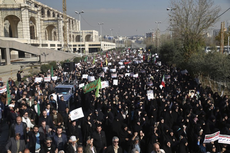Iranian protesters chant slogans at a rally in Tehran on Saturday. Iranian hard-liners rallied Saturday to support the country's supreme leader and clerically overseen government as spontaneous protests sparked by anger over the ailing economy roiled major cities in the Islamic Republic.