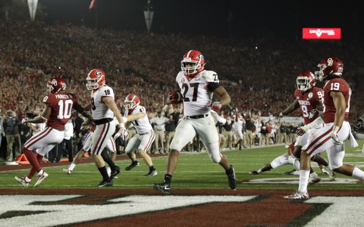 Georgia running back Nick Chubb scores a touchdown and the Bulldogs beat Oklahoma 54-48 in double overtime on Monday in Pasadena, California to advance to the national championship game.