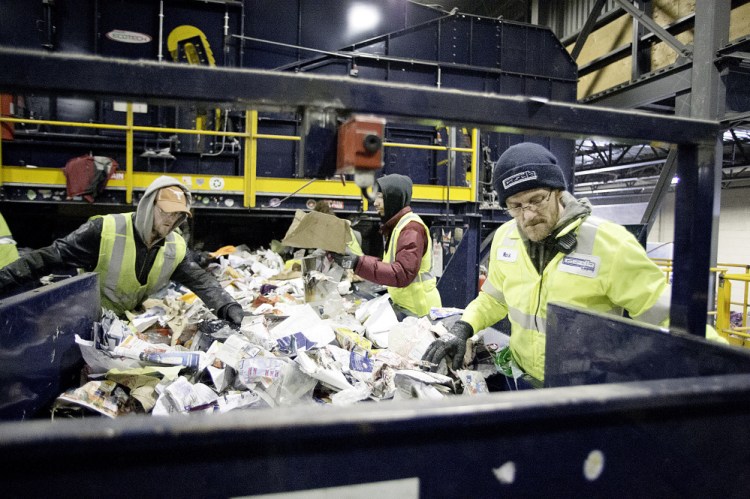 Employees sort recycled waste from area communities at the Casella Pine Tree Waste facility in Lewiston.