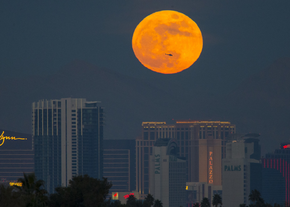 The first supermoon of 2018 rises above the Vegas Strip on Monday. A second full moon, or blue moon, arrives on Jan. 31.