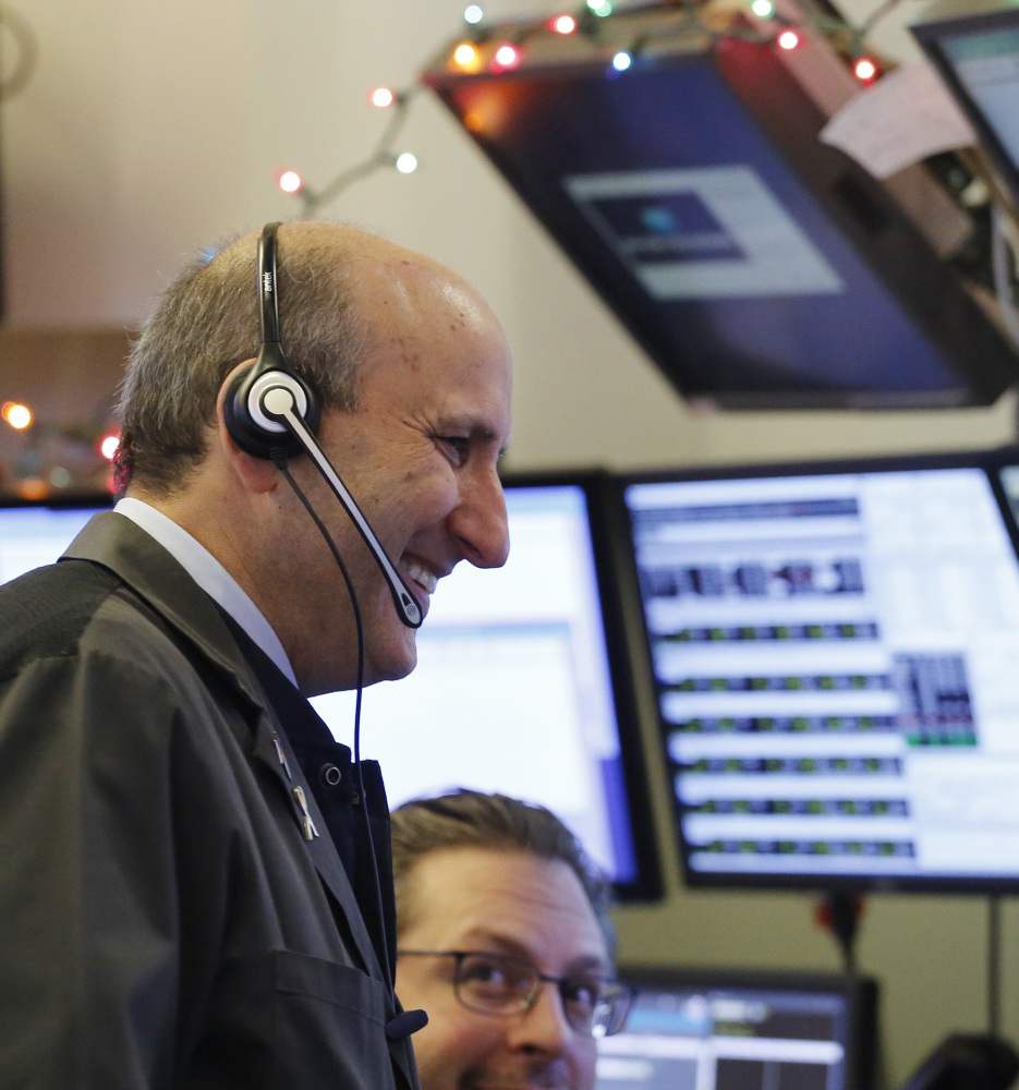 Traders work the stock exchange floor Tuesday as the Nasdaq had its best opening day since 2013.
