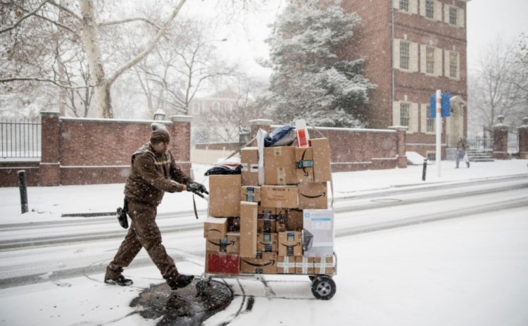 A United Parcel Service worker makes his deliveries during a snowstorm in Philadelphia on Dec. 15. An estimated 25-30 percent of online purchases are sent back, about triple the rate for items bought in-store.