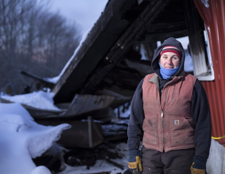 Heather Donahue of Balfour Farm in Pittsfield stands next to a structure that housed a commercial kitchen that was destroyed in a fire several weeks ago.