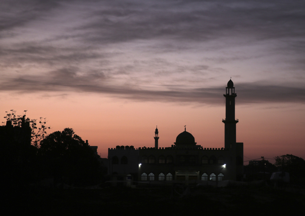 The sun rises over a mosque in Gaza City. In recent weeks, Gaza residents have been jolted awake in the dead of night to a raucous mixture of Quranic phrases, Islamic supplications and prayers delivered to their doorsteps.