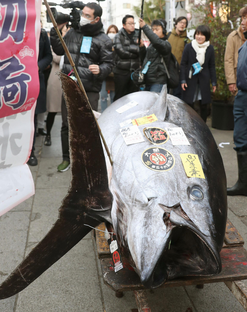 This 892-pound bluefin tuna sells for $320,000 Friday at the annual New Year auction at Tsukiji fish market in Tokyo. The market is expected to open at its new location, Toyosu, on Oct. 11.