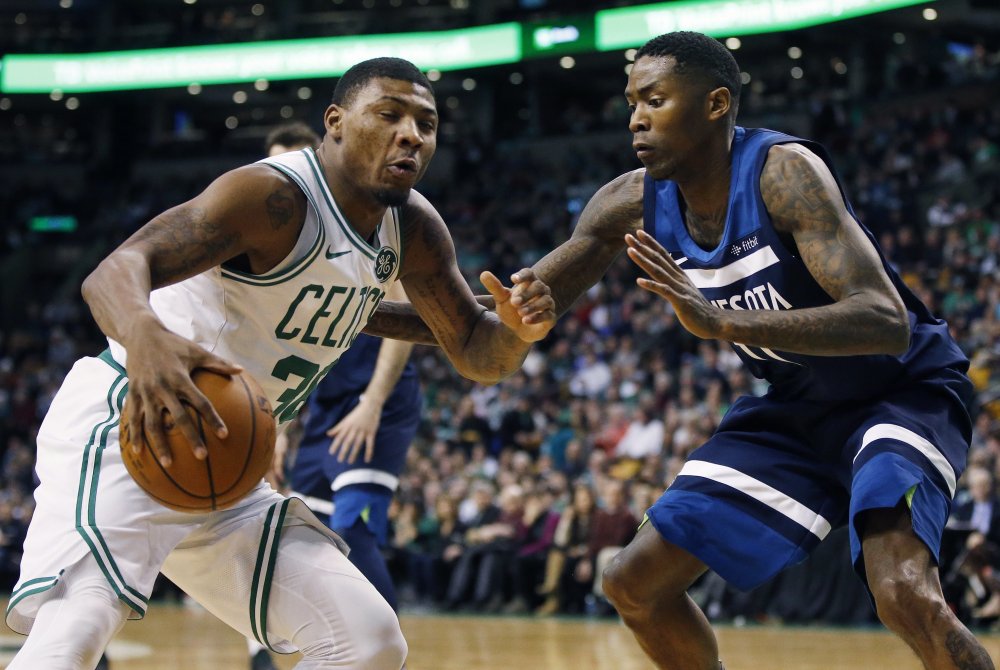 Minnesota's Jamal Crawford guards Boston's Marcus Smart in the second quarter of Friday night's game in Boston.