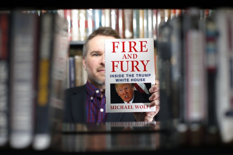Kevin Davis, director of the South Portland Public Library, with "Fire and Fury," which President Trump has assailed. The library was listed online Friday as the only one in Maine with a copy.